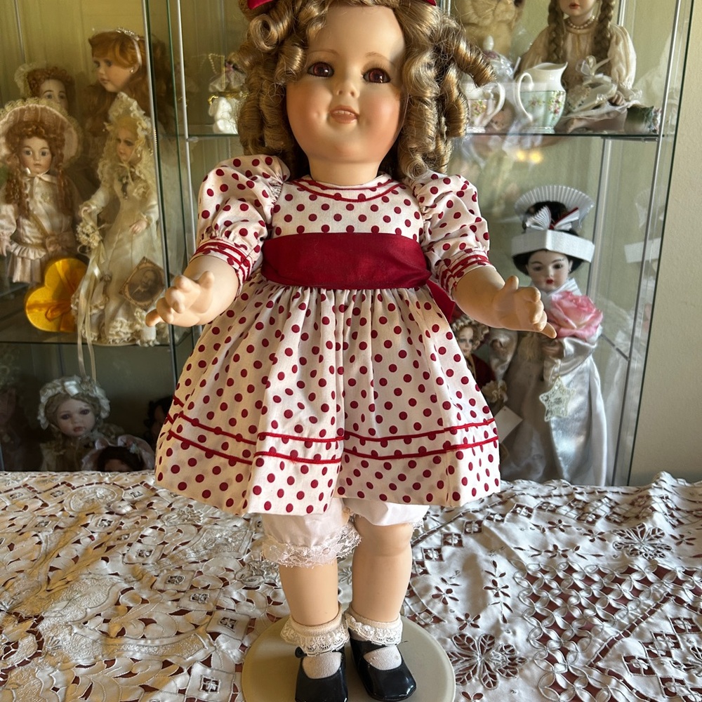 Sherly Temple is full body porcelain reproduction doll.